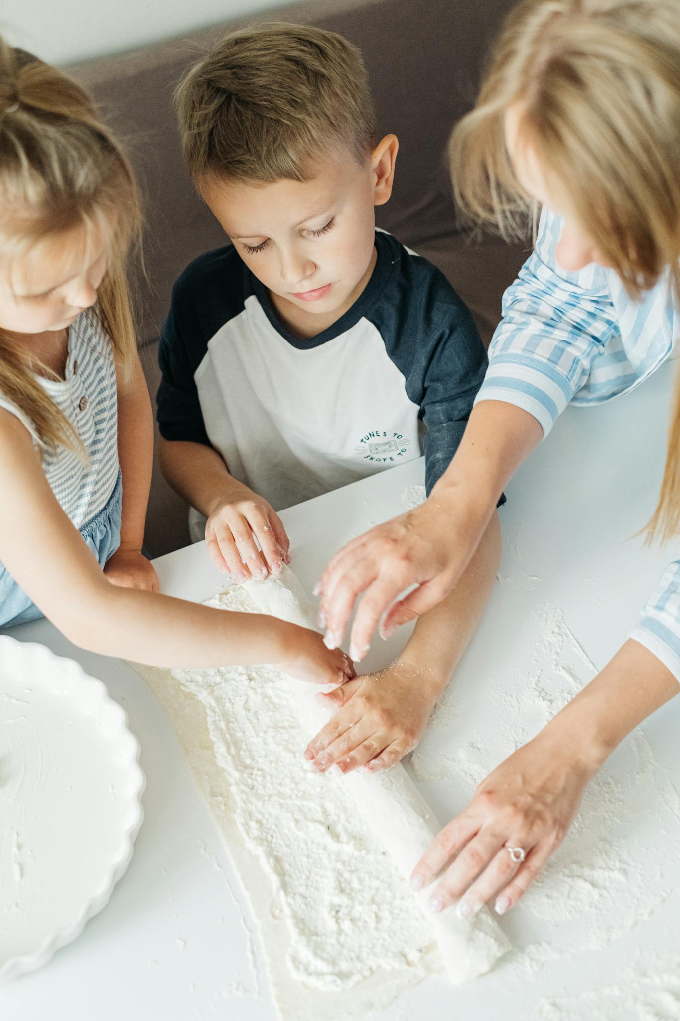 Girl in White and Black Crew Neck T-shirt Holding White Round Cake