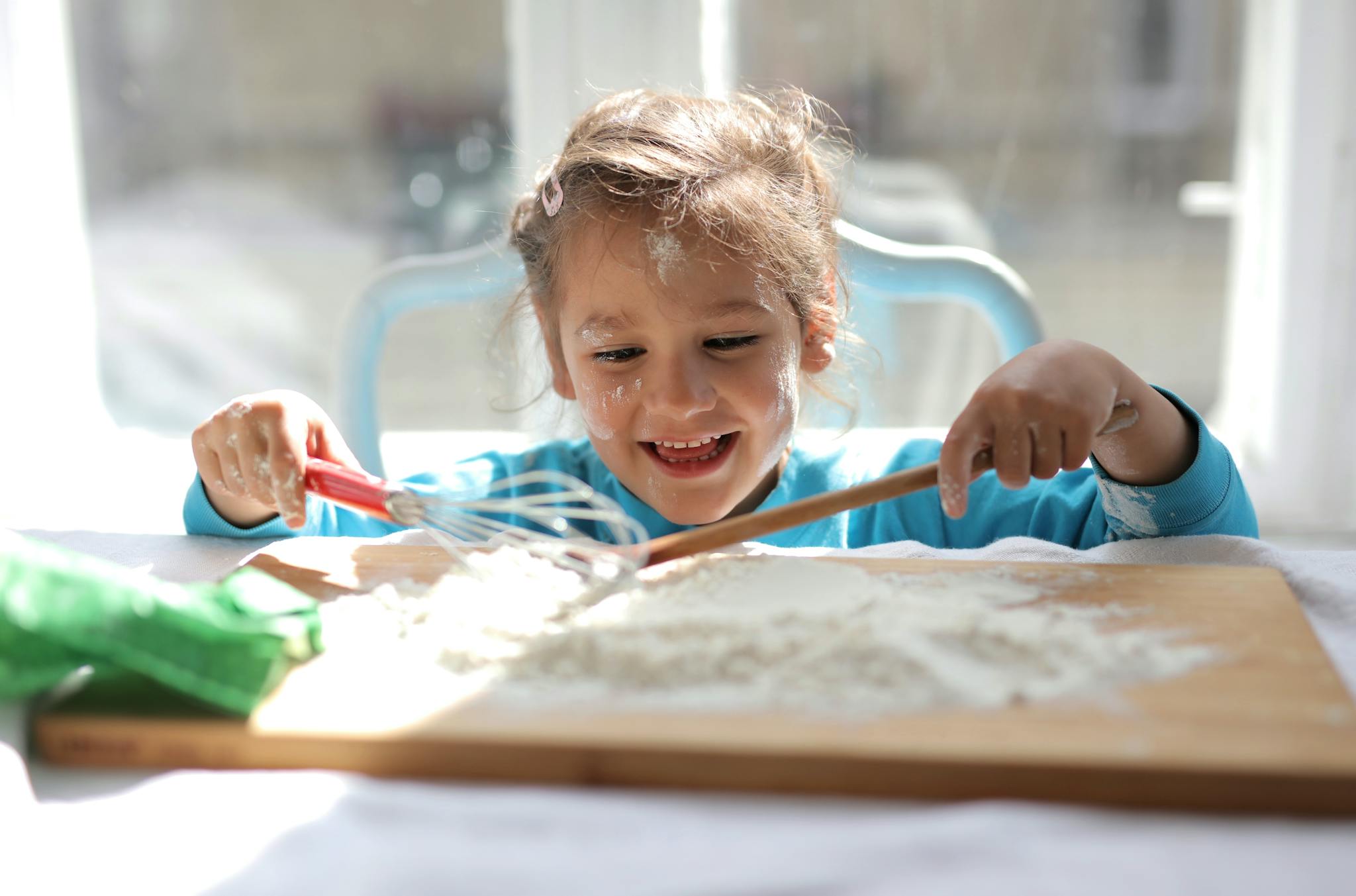 girl playing with kitchen equipment