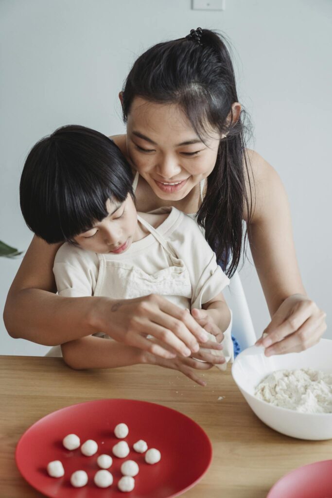 Mother Teaching Child to Cook