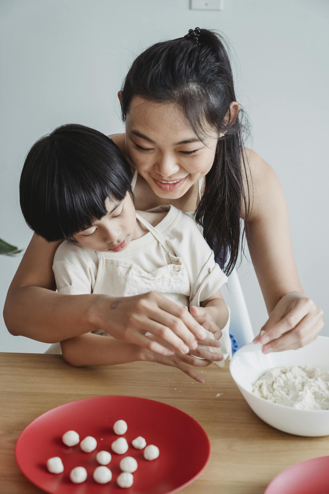 mother teaching child to cook